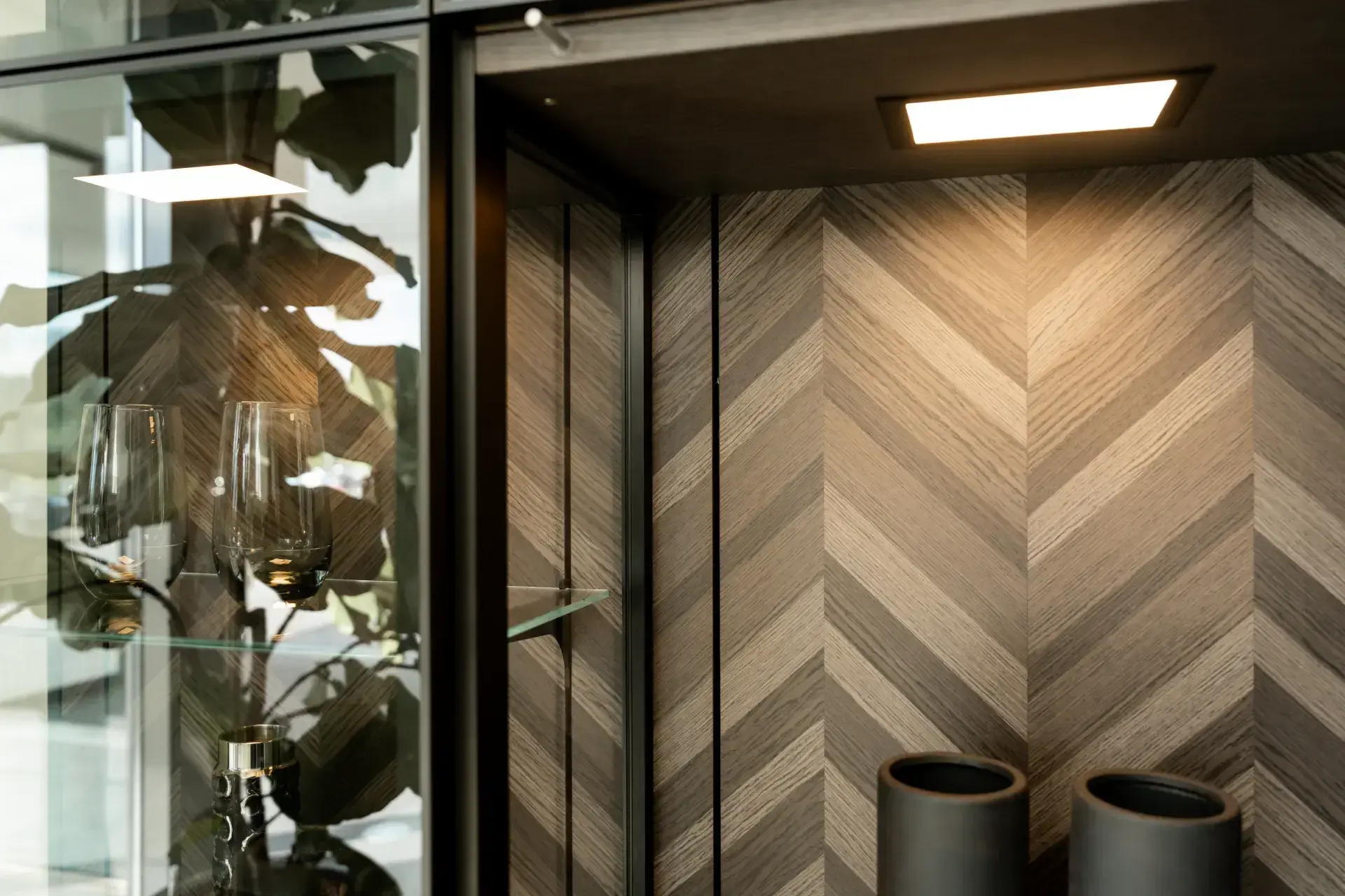 Detail van SieMatic houtfineer met visgraatpatroon in vitrinekast