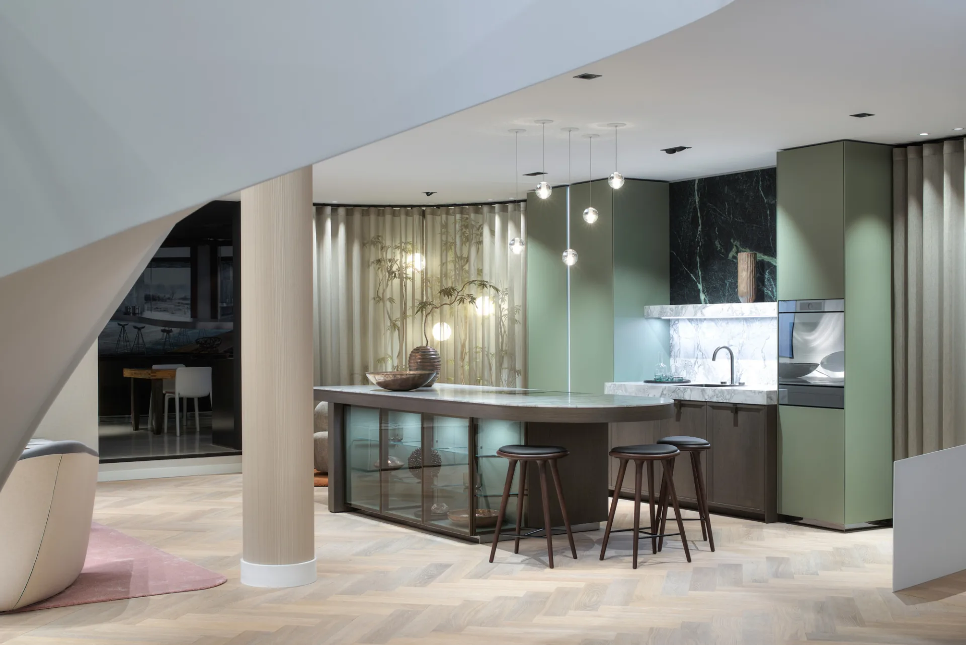 SieMatic Mondial showroom kitchen in Helmond featuring green lacquer, display cabinets, and a marble-look countertop.