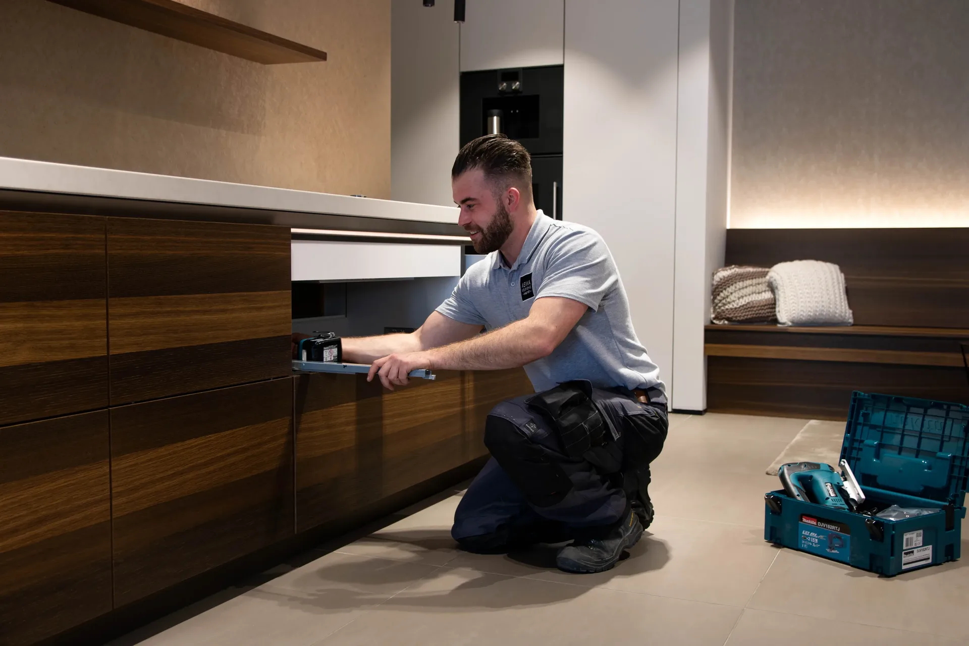 A kitchen installer assembles a custom kitchen with an eye for precision and finish.